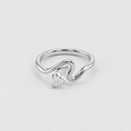 A silver ring with a curved, wave-like band and a marquise-cut clear gemstone, photographed on a clean white background.