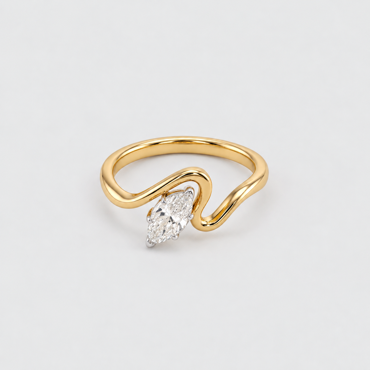 A gold ring with a wavy, open band design and a marquise-cut diamond set in a silver-colored prong, shown on a light gray background.