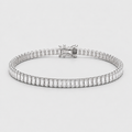 A silver tennis bracelet featuring a row of baguette-cut clear gemstones, displayed on a light gray background.