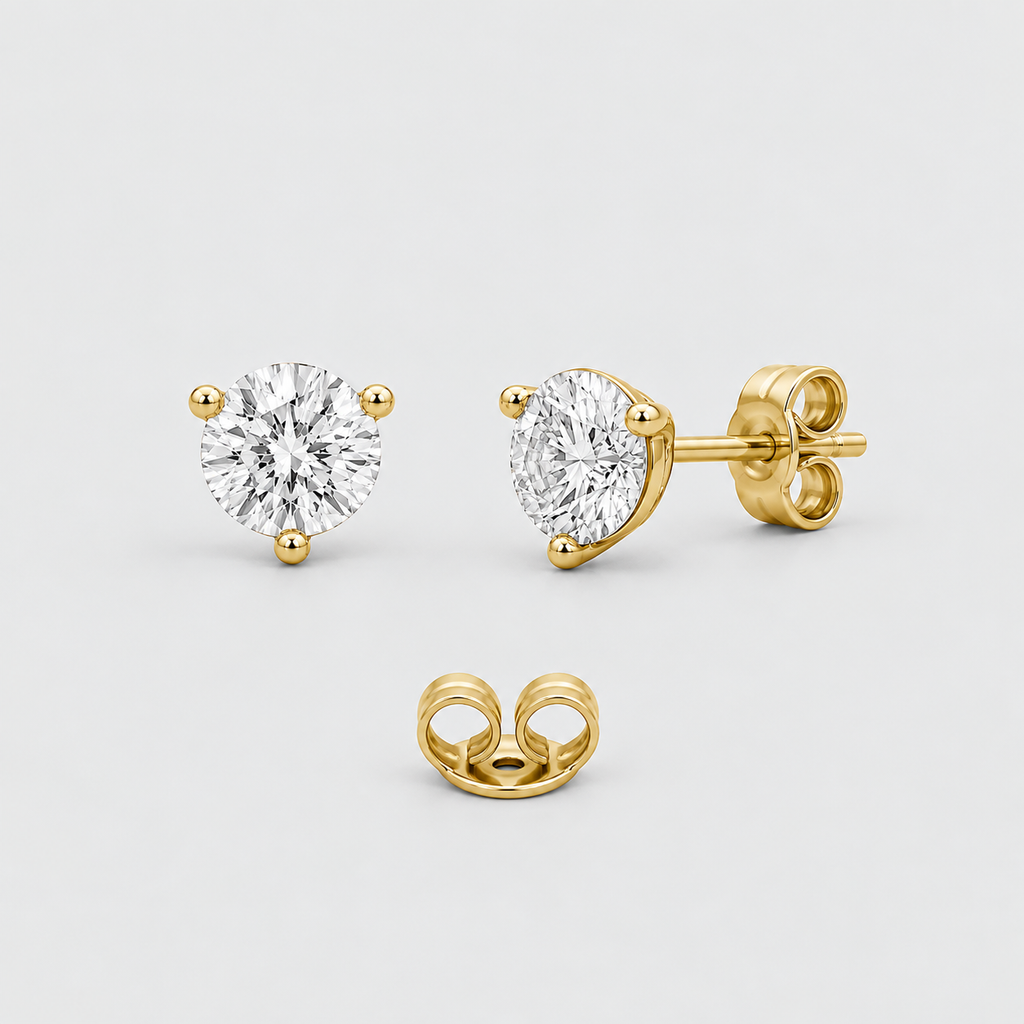 Three views of a pair of yellow gold stud earrings with round brilliant-cut clear gemstones, showing the front, side profile, and butterfly back on a light gray background.