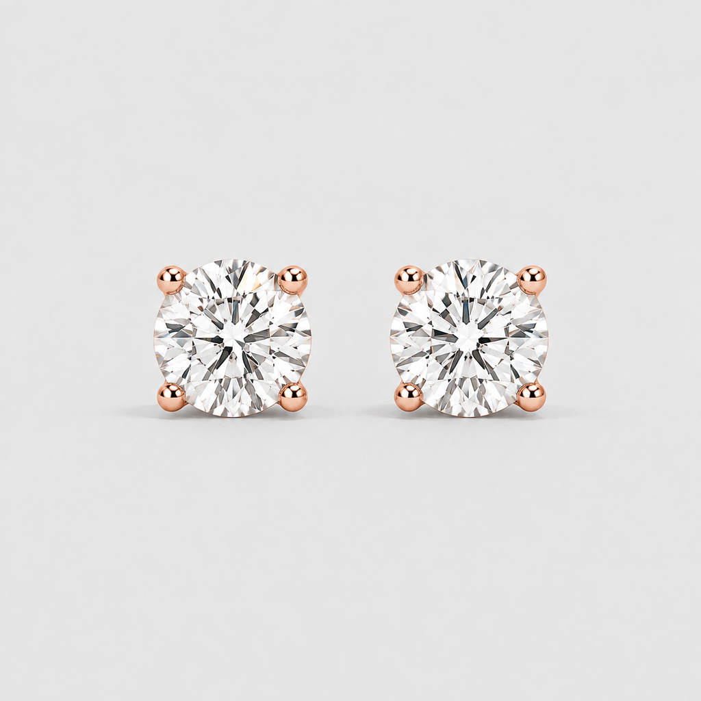 A pair of round-cut diamond stud earrings in four-prong rose gold settings, shown on a light gray background.
