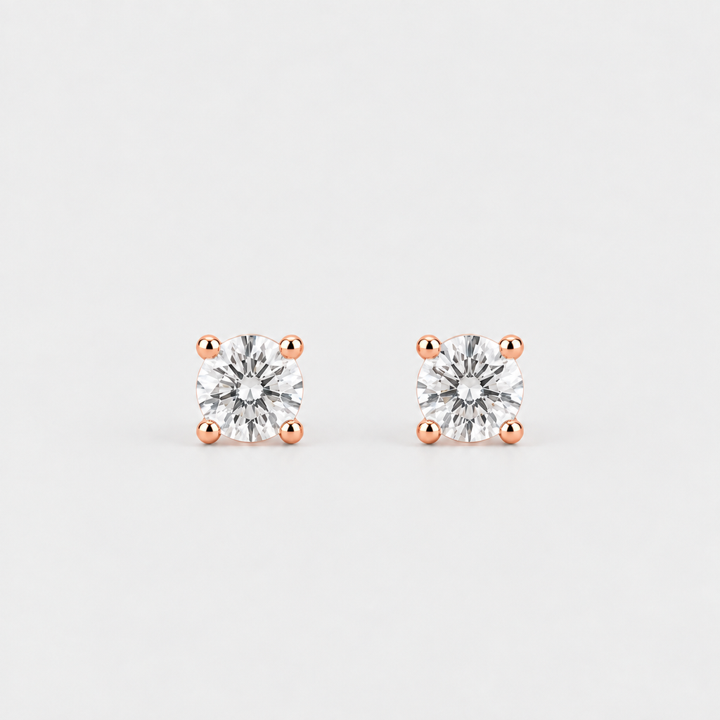 A pair of square-cut stud earrings featuring clear gemstones in four-prong rose gold settings, displayed on a clean light gray background.