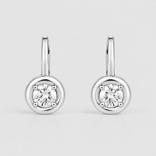 A pair of silver stud earrings with round bezel-set clear gemstones, displayed on a light gray background.