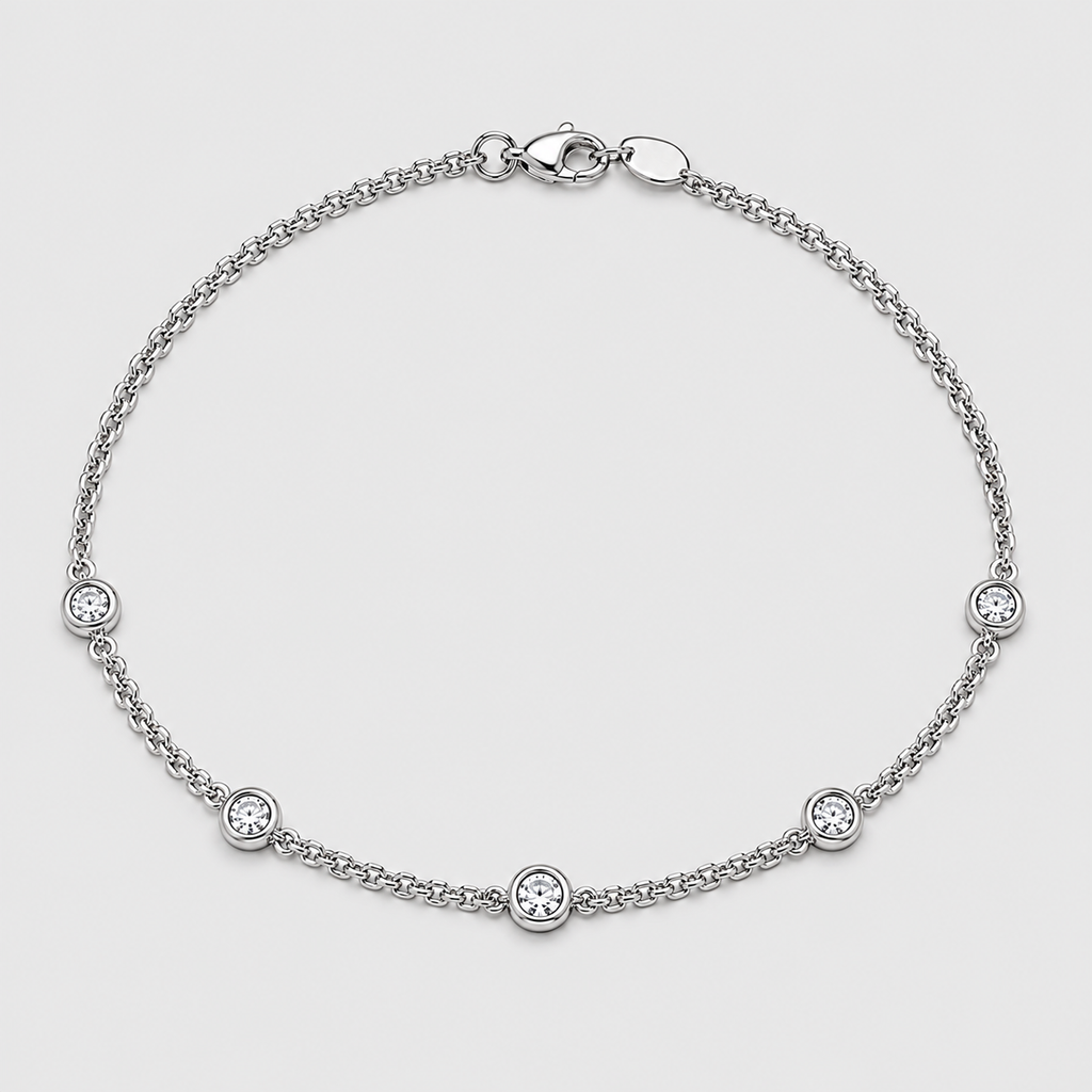 A silver chain bracelet with five small bezel-set round clear stones, displayed on a light gray background.