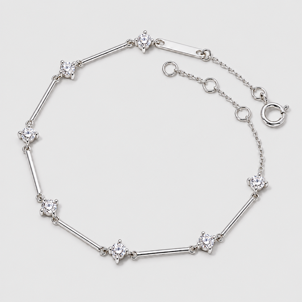 A silver-toned bracelet featuring alternating segments of polished bars and star-shaped settings with clear gemstones, displayed on a light gray background.