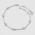 A silver-toned bracelet featuring alternating segments of polished bars and star-shaped settings with clear gemstones, displayed on a light gray background.