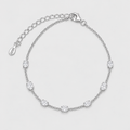 A silver chain bracelet with seven oval-cut clear stones spaced evenly along the band, featuring an adjustable lobster clasp and extension chain with a small engraved tag that reads VVD.