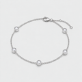 A silver chain anklet with five bezel-set clear round stones, displayed on a light gray background.