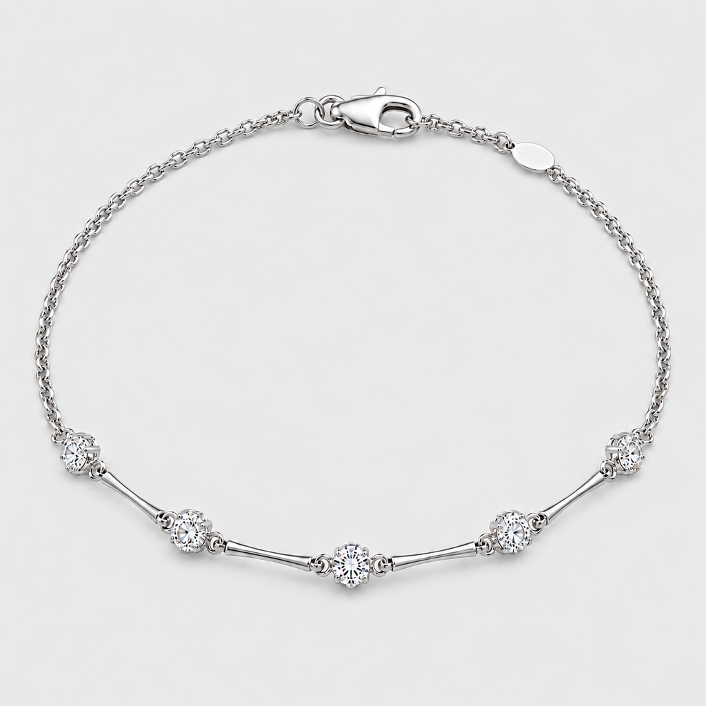 A silver chain bracelet with a lobster clasp, featuring five clear round-cut and oval pavé diamonds spaced along the chain, set against a clean light gray background.