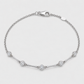 A silver chain bracelet with a lobster clasp, featuring five clear round-cut and oval pavé diamonds spaced along the chain, set against a clean light gray background.