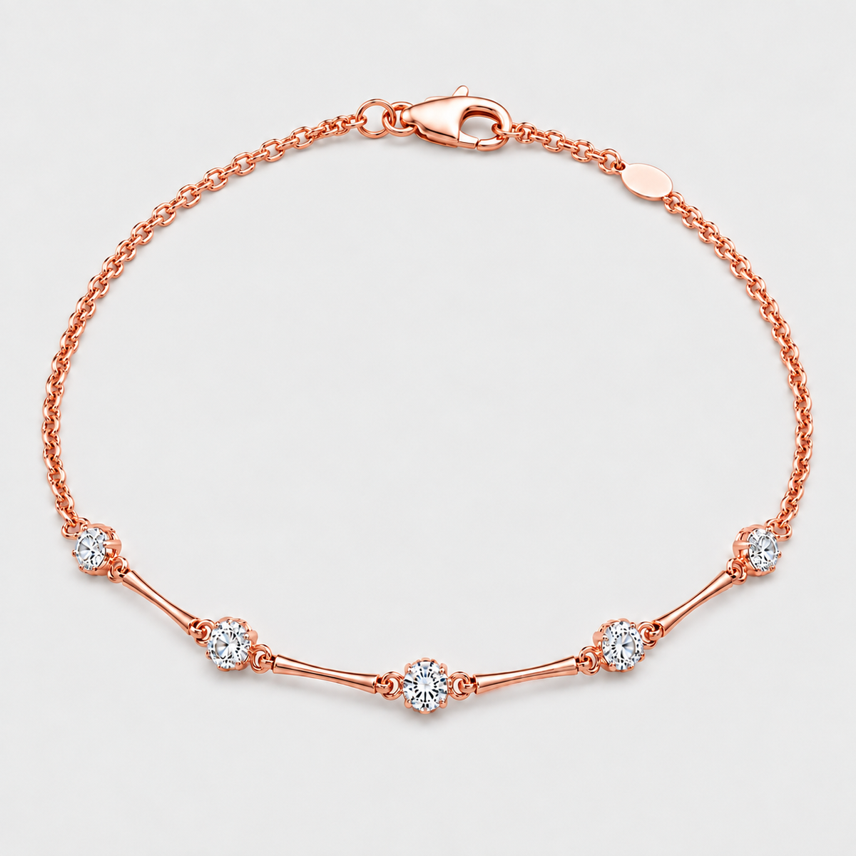 A rose gold chain bracelet with five floral clusters of clear round-cut gemstones, displayed on a light gray background.