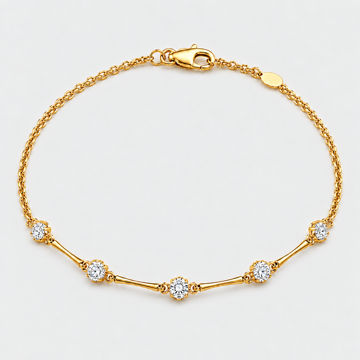 A yellow gold chain bracelet with a lobster clasp and five floral diamond settings, photographed on a clean white background.