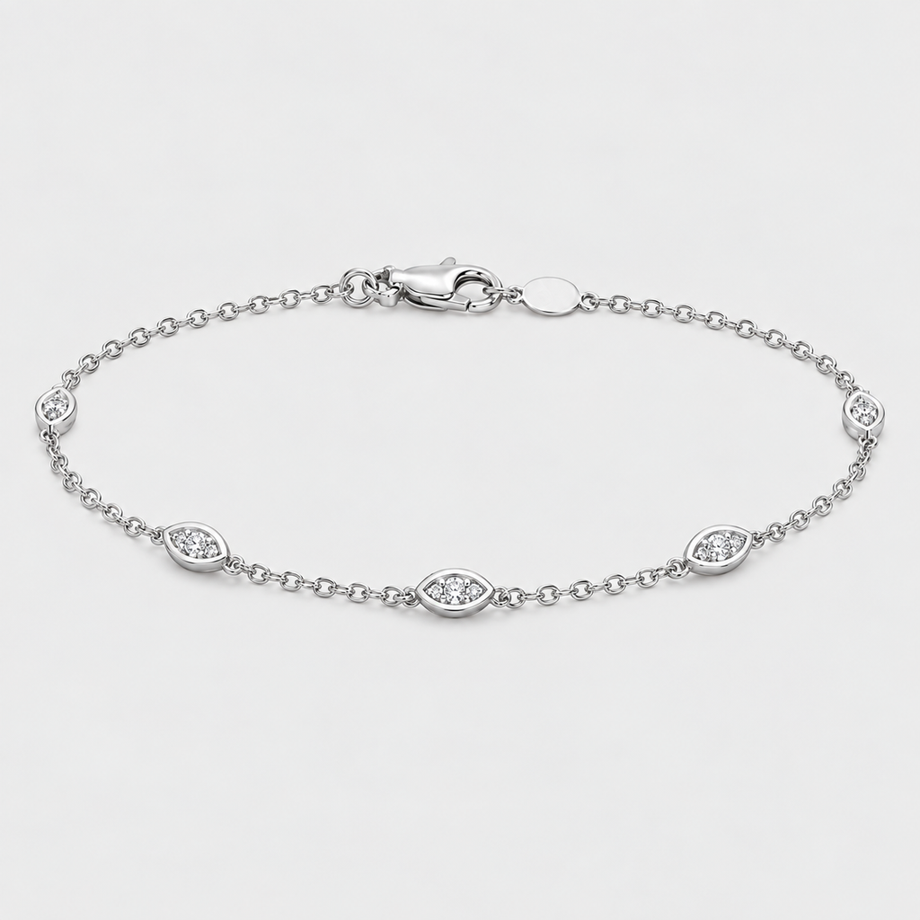 A silver chain bracelet with five oval eye-shaped links, each set with a small clear gemstone, displayed on a light gray background.