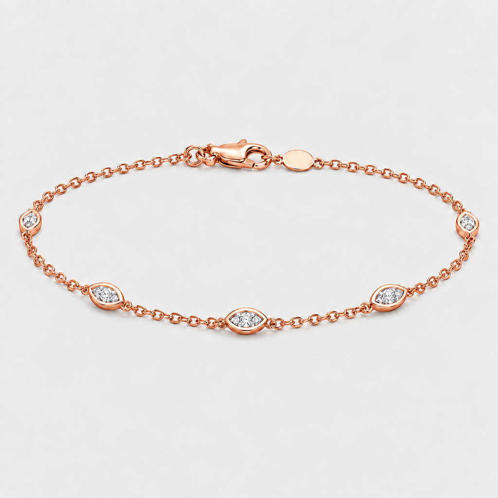 A rose gold chain bracelet with five oval bezel-set clear gemstones, displayed on a light gray background.