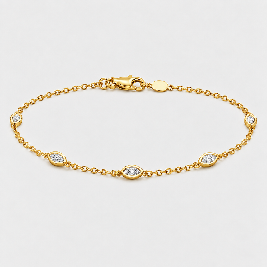 A gold chain bracelet with five marquise-cut diamond accents set in oval bezels, displayed on a clean light gray background.