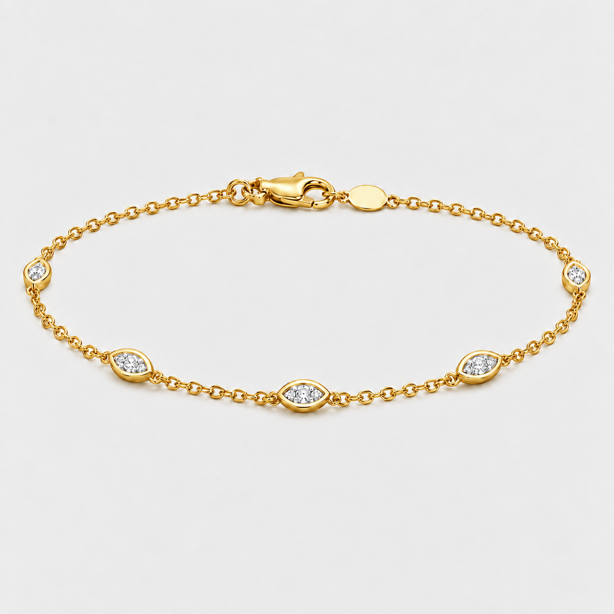 A gold chain bracelet with five marquise-cut diamond accents set in oval bezels, displayed on a clean light gray background.