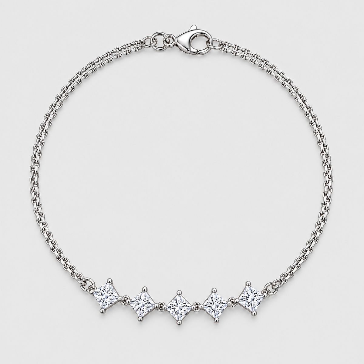 A silver chain bracelet with five diamond-cut clear stones set in a row, displayed on a light gray background.