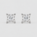 A pair of princess-cut diamond stud earrings in a silver four-prong setting, displayed on a clean light gray background.