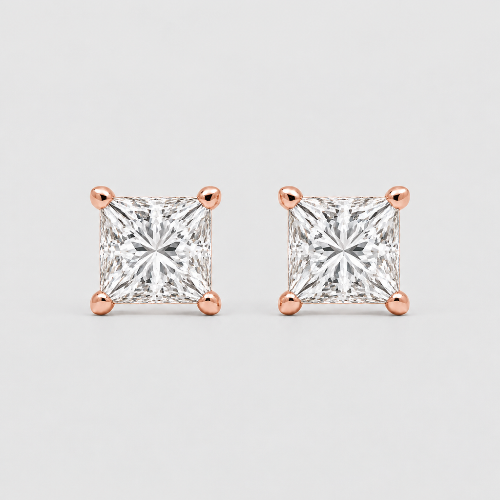 A pair of princess-cut diamond stud earrings in rose gold four-prong settings, shown on a light gray background.