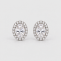 A pair of oval halo stud earrings featuring marquise-cut center stones surrounded by small round stones in a silver-toned setting, photographed on a light gray background.