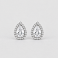 A pair of pear-shaped halo stud earrings featuring a large clear center stone surrounded by a border of smaller round stones in a silver-toned setting, shown on a light gray background.