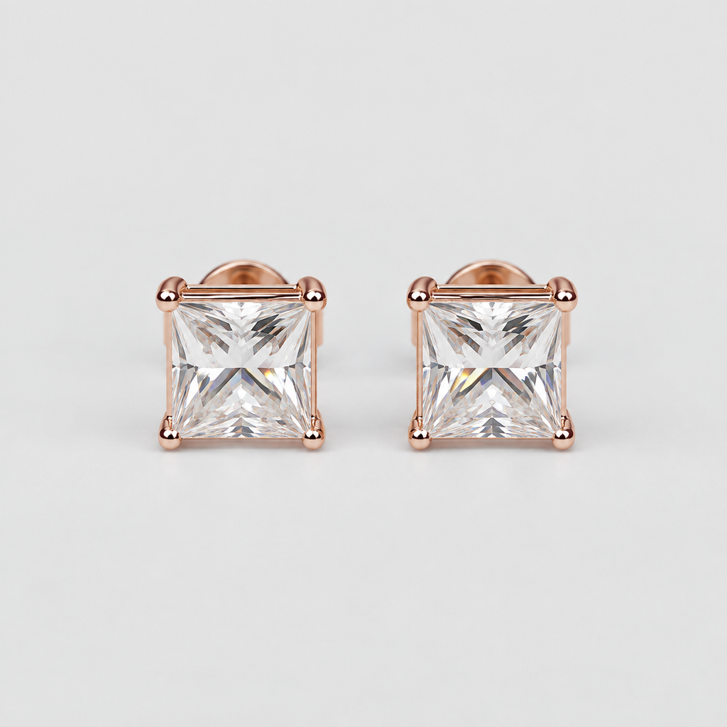 A pair of princess-cut clear gemstone stud earrings in rose gold settings, photographed on a clean light gray background.