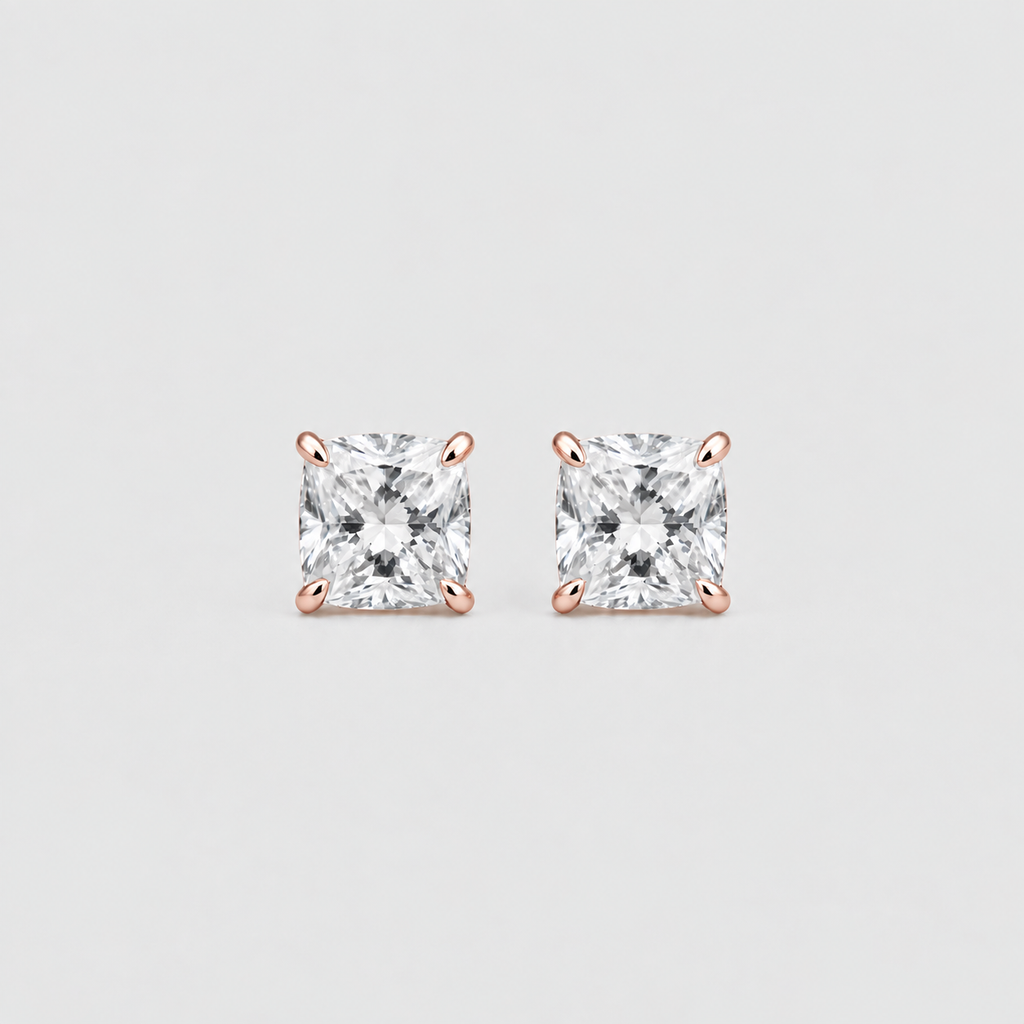 A pair of princess-cut diamond stud earrings in four-prong rose gold settings, centered on a light gray background.