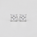 A pair of princess-cut diamond stud earrings in a silver-toned setting, displayed on a clean, light gray background.
