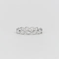 A silver diamond eternity band ring featuring a continuous row of marquise and round-cut diamonds, shown on a neutral light gray background.