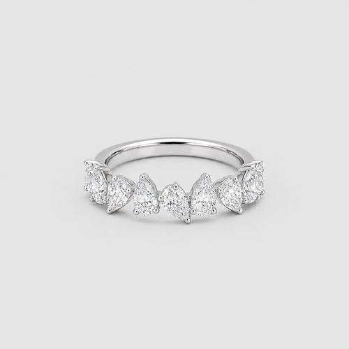 A silver band ring featuring a row of marquise-cut and round-cut clear gemstones, photographed on a light gray background.