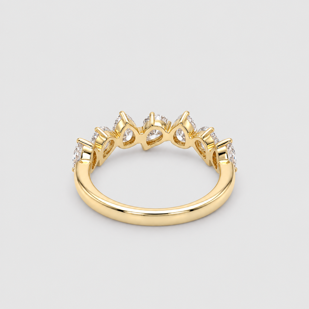 A yellow gold ring featuring a crown-like top with clear gemstones, shown on a neutral light gray background.