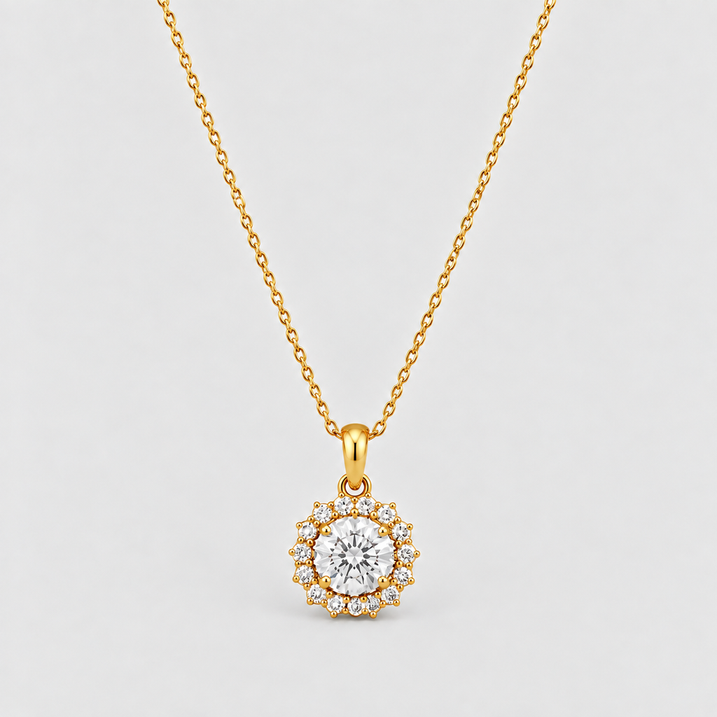 A gold necklace with a circular pendant featuring a central clear gemstone surrounded by a halo of smaller clear stones, displayed on a light gray background.