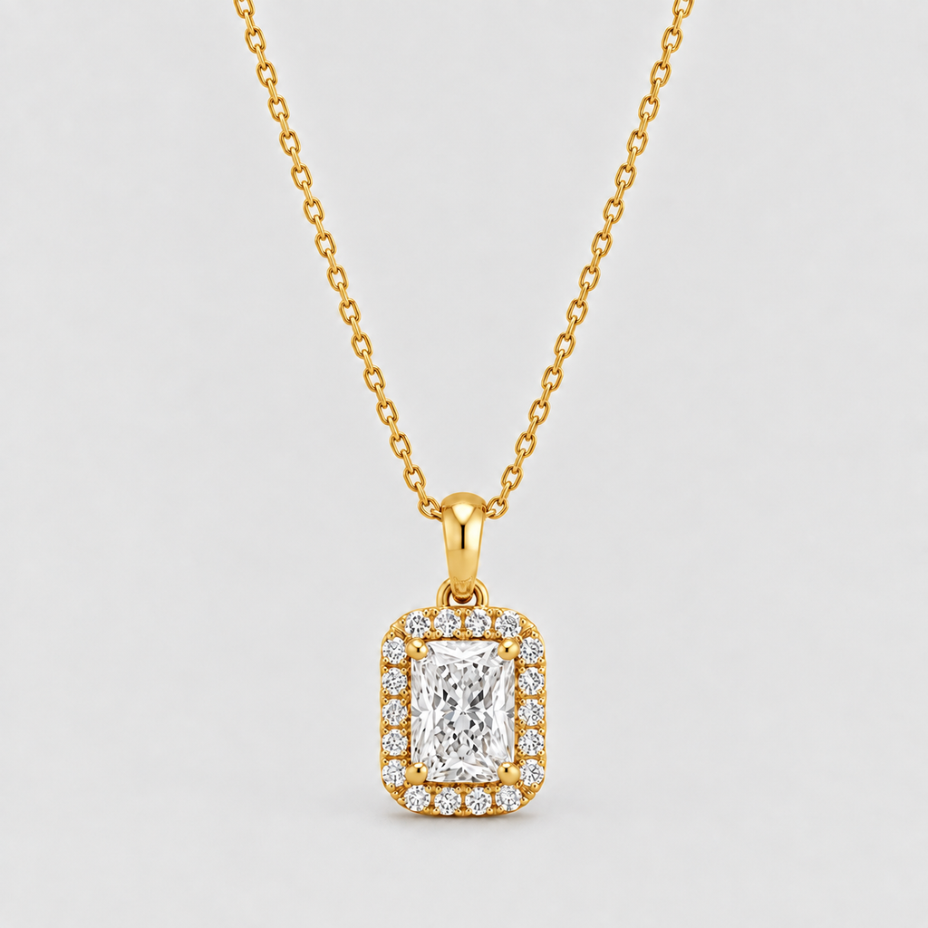 A yellow gold necklace with a rectangular halo pendant featuring a central emerald-cut diamond surrounded by smaller diamonds, shown on a light gray background.