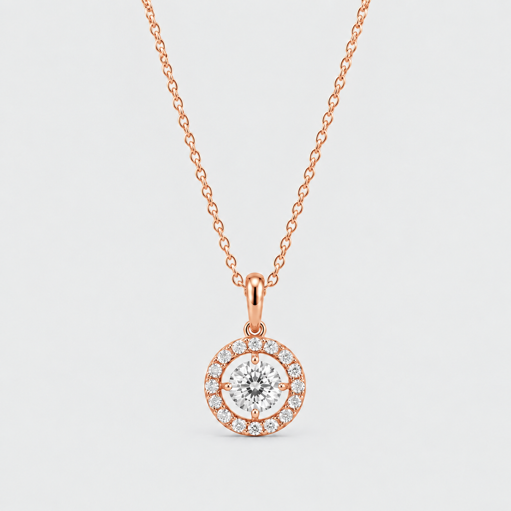 A rose gold pendant necklace featuring a round-cut center stone surrounded by a halo of small pavé-set stones, suspended from a delicate rose gold chain against a light gray background.