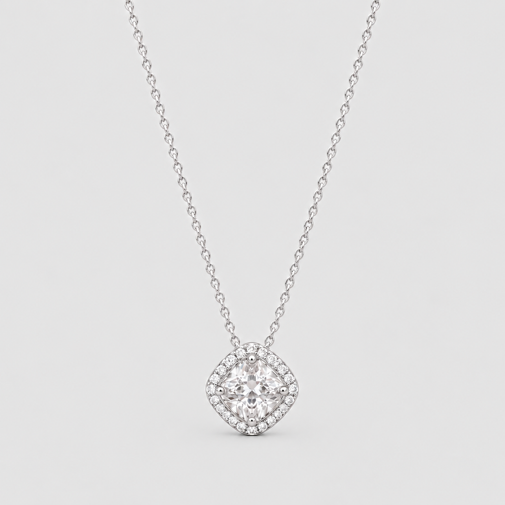 A silver-tone diamond halo necklace with a cushion-cut center stone, displayed on a light gray background.