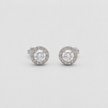 A pair of round halo stud earrings in silver-toned metal, featuring a central clear gemstone surrounded by a halo of smaller clear stones, set against a plain light gray background.