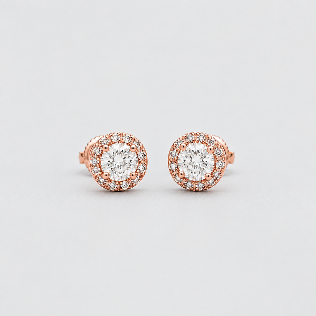 A pair of rose gold halo stud earrings with round-cut clear gemstones, set against a clean light gray background.