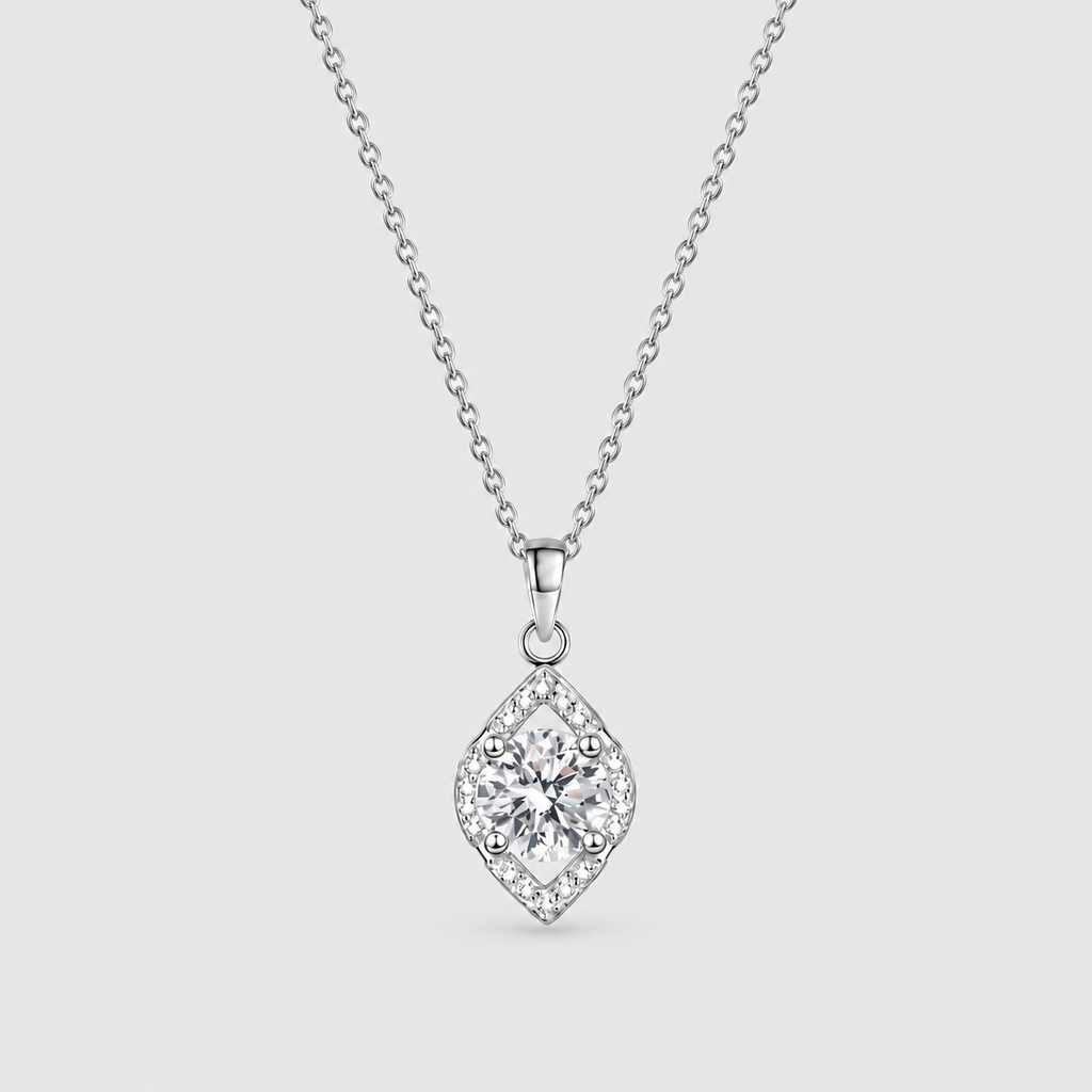 A silver diamond-shaped pendant necklace featuring a central round-cut diamond surrounded by a halo of smaller diamonds, suspended from a delicate silver chain against a light gray background.