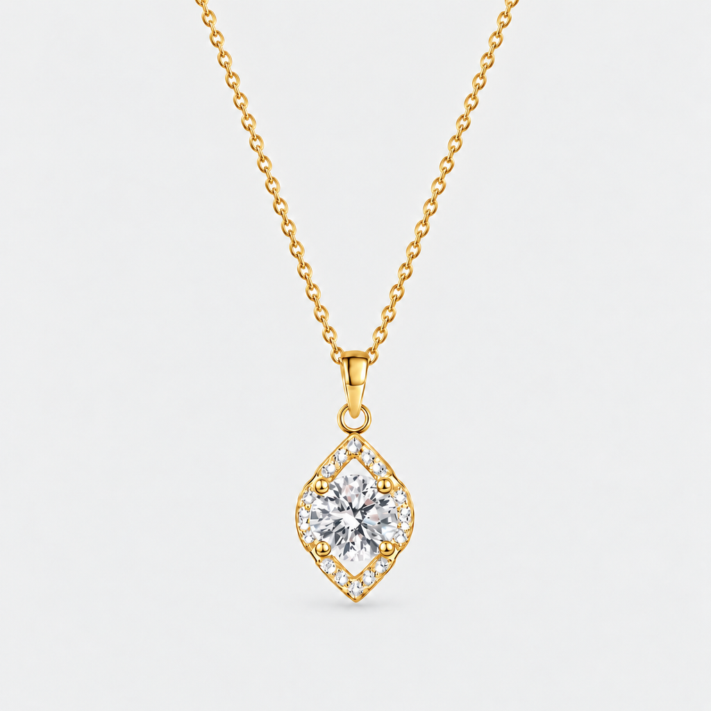 A gold diamond-shaped pendant necklace featuring a central clear gemstone surrounded by a halo of small diamonds, suspended from a delicate gold chain against a light gray background.