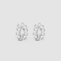 A pair of silver-toned stud earrings featuring marquise-cut and round-cut clear gemstones arranged in a floral or snowflake-like cluster, set against a solid light gray background.
