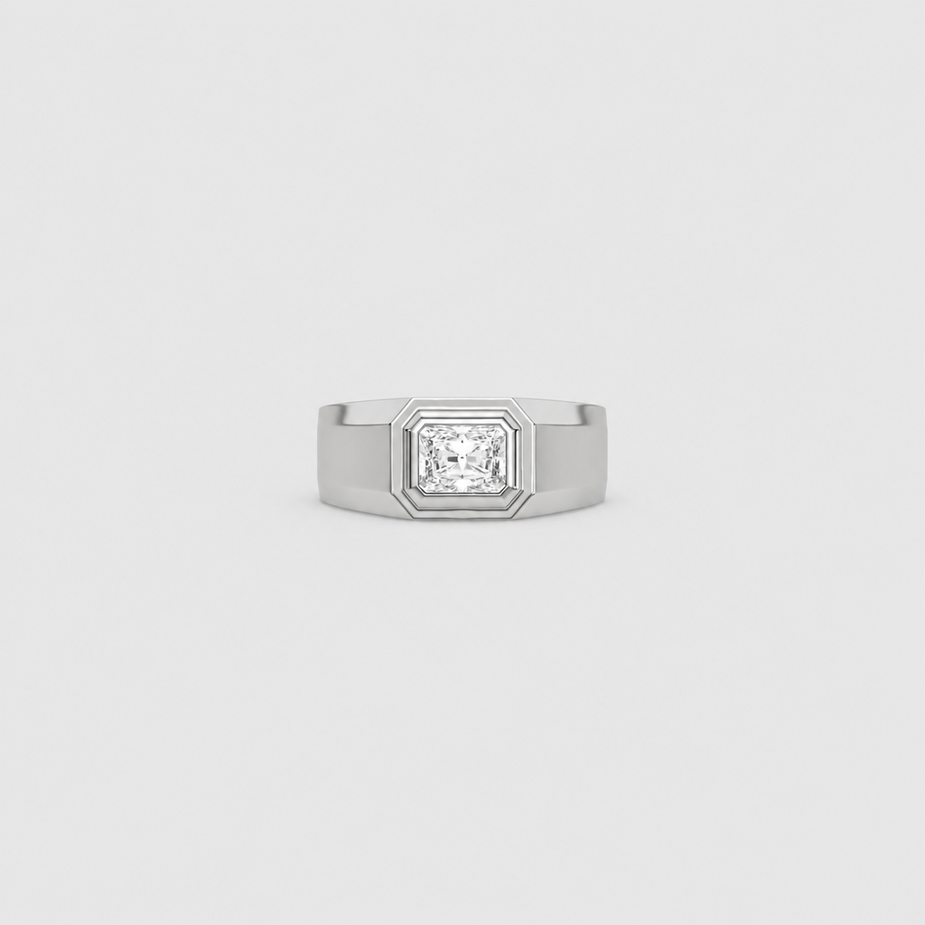 A silver-toned men's ring featuring a square bezel-set princess-cut diamond, centered on a light gray background.