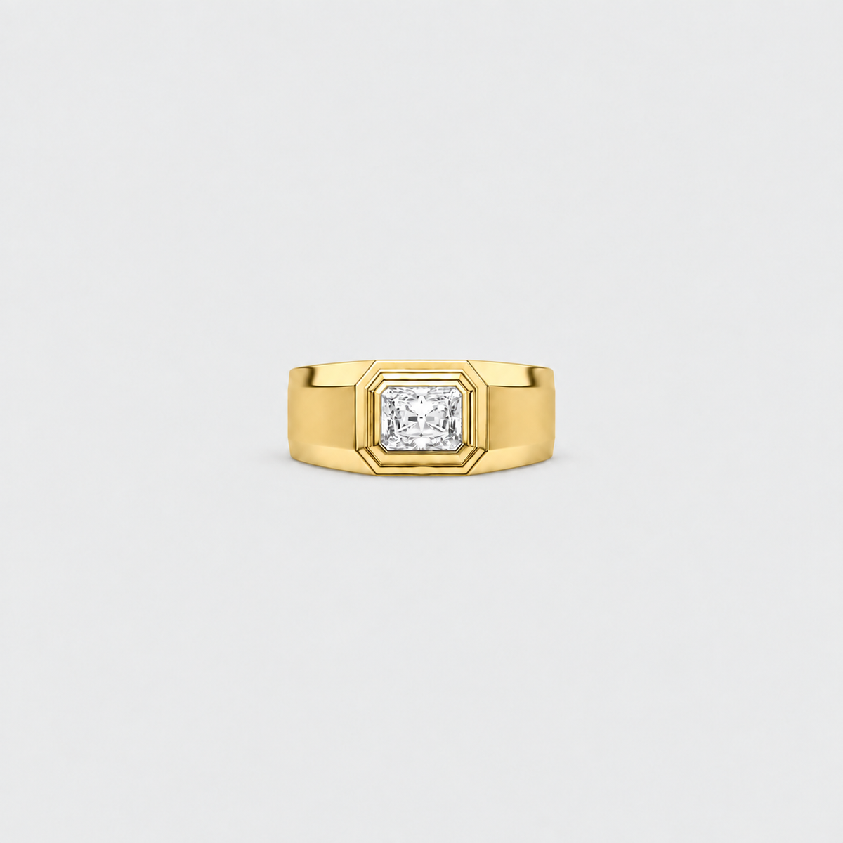 A yellow gold ring with a square bezel setting holding a princess-cut diamond, centered on a light gray background.