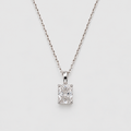 A silver-toned necklace with a rectangular emerald-cut diamond pendant, displayed against a clean light gray background.