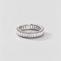 A silver eternity ring featuring baguette-cut clear stones, photographed on a clean, light gray background.