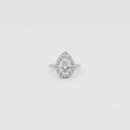 A pear-shaped halo ring featuring a central round-cut diamond surrounded by a double halo of smaller diamonds, set in a silver-colored metal band on a light gray background.