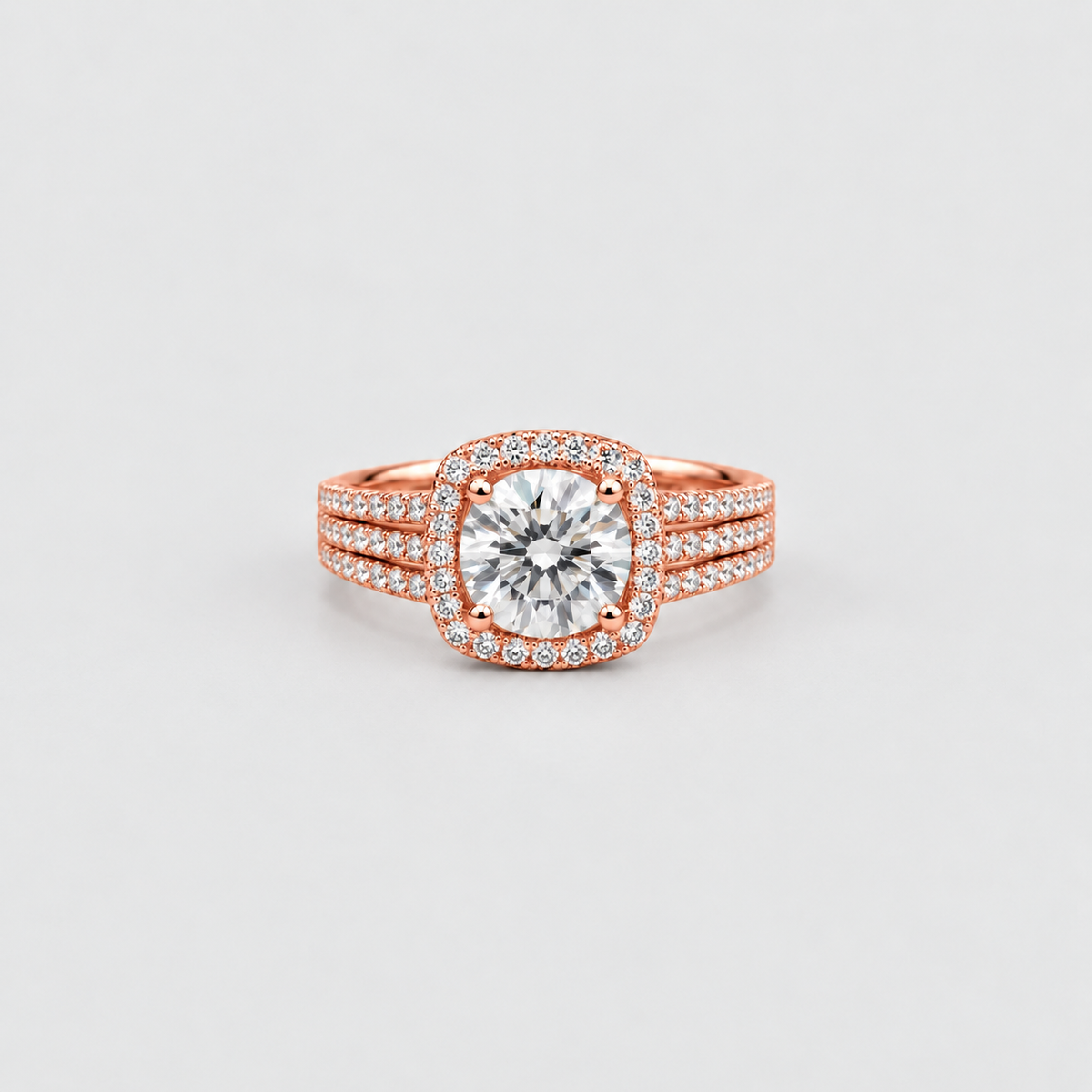 A rose gold ring featuring a large round-cut center stone surrounded by a halo of smaller stones, with a three-stripe shank also paved with small stones, set against a light gray background.