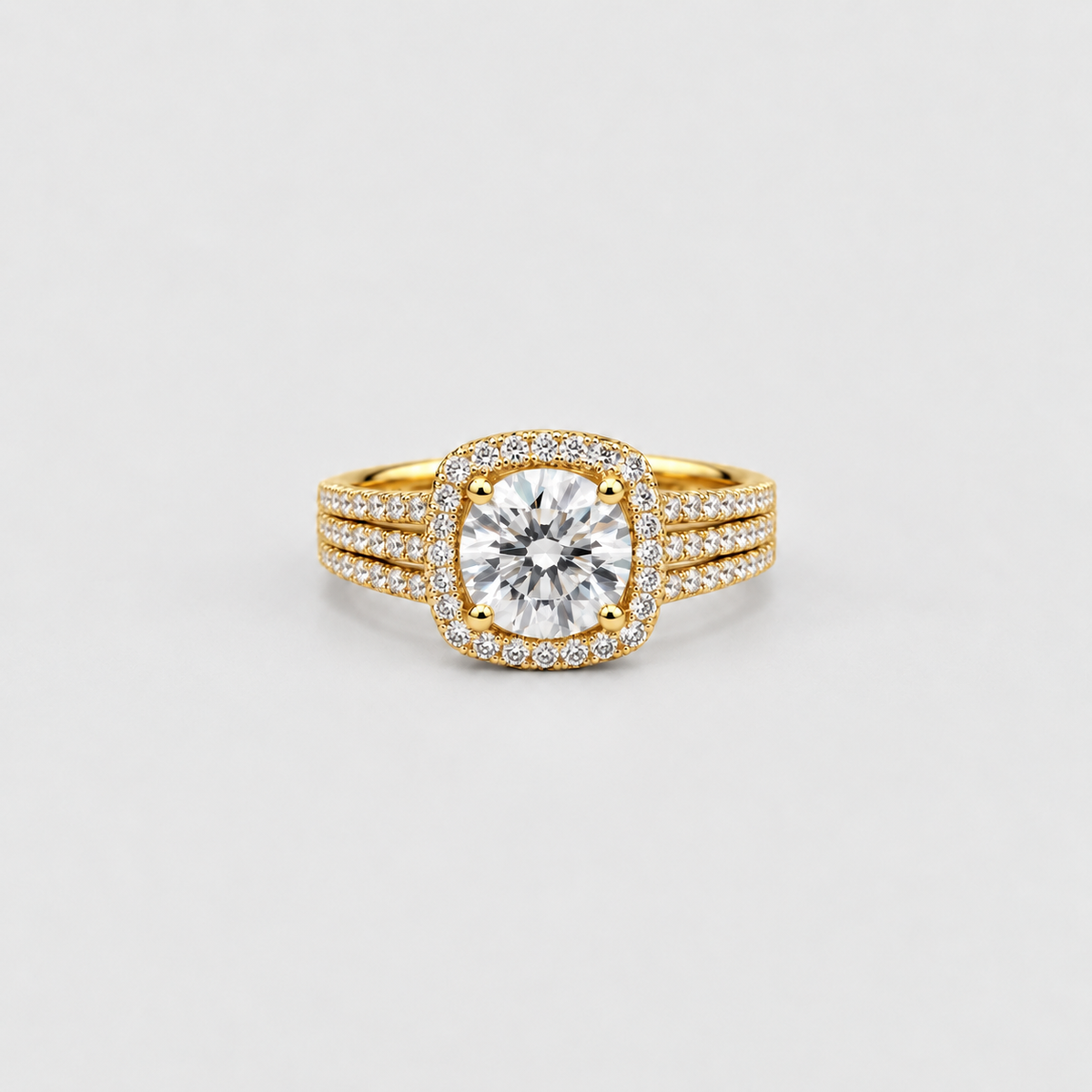 A yellow gold ring featuring a round-cut diamond center stone surrounded by a halo, with three pavé-set diamond bands, shown on a light gray background.