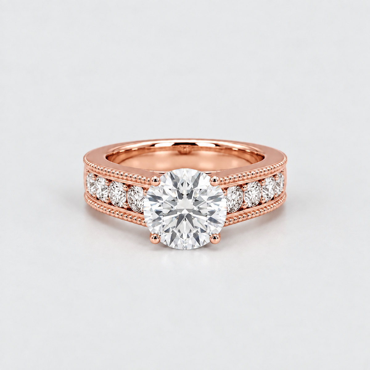 A rose gold engagement ring featuring a round-cut center stone and channel-set round diamonds on a clean, light gray background.