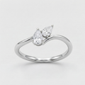 A silver-tone ring featuring two pear-cut clear gemstones in a prong setting on a curved band, photographed on a clean light gray background.