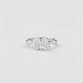 A silver double diamond ring with two pear-cut diamonds in a three-prong setting, shown on a light gray background.